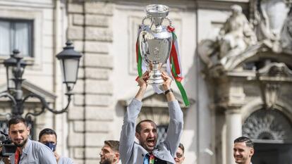 Los jugadores de la selección italiana levantan el trofeo a su llegada a Roma.