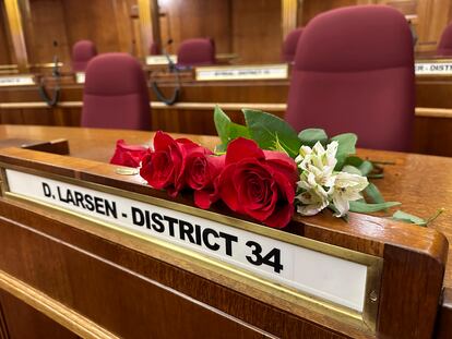 Roses rest on the Senate desk of late North Dakota Republican state Sen. Doug Larsen, at the state Capitol Monday, Oct. 2, 2023, in Bismarck, N.D.