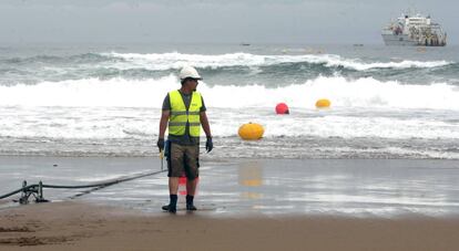 A workman checks that the cable is positioned correctly.