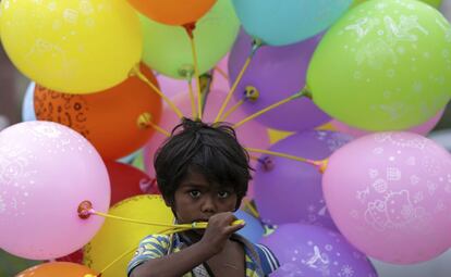 Un niño vende globos en una calle de Bombay, India.