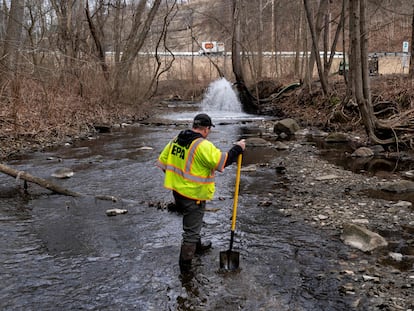 Ron Fodo, Ohio EPA Emergency Response, looks for signs of fish and also agitates the water in Leslie Run creek to check for chemicals that have settled at the bottom following a train derailment that is causing environmental concerns on February 20, 2023 in East Palestine, Ohio.