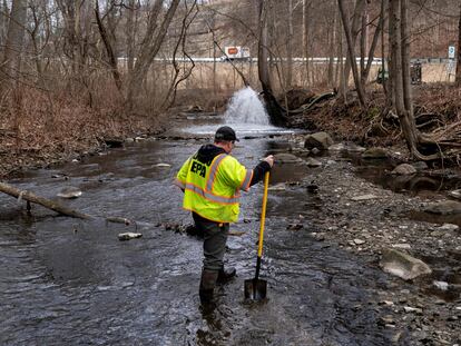 Ron Fodo, Ohio EPA Emergency Response, looks for signs of fish and also agitates the water in Leslie Run creek to check for chemicals that have settled at the bottom following a train derailment that is causing environmental concerns on February 20, 2023 in East Palestine, Ohio.