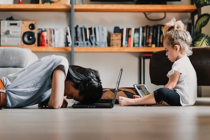 Young mother exhausted working from home with daughter