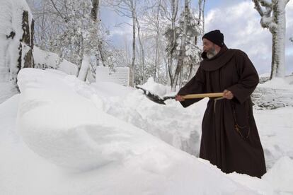 José, fraile que cuida el Santuario de O Cebreiro, retira con una pala la nieve acumulada en los alrededores de la ermita. La fuerte nevada que ha caído sobre la zona sur y la Montaña de Lugo ha dejado incomunicados a varios núcleos de población en los municipios de Pedrafita do Cebreiro, Cervantes y O Courel, donde el viento ha compactado la nieve, lo que hace más difícil su retirada.