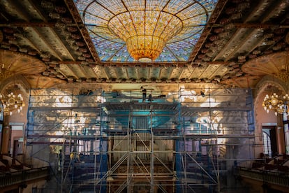 Un operario trabaja en el Palau de la Música durante la restauración del conjunto escultórico del escenario.