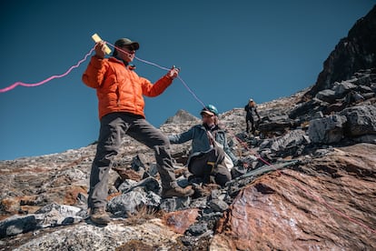 Scientists work with a geotextile cover on La Corona glacier.
