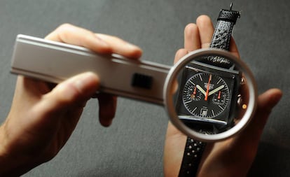 Un empleado de la firma observa con detalle un reloj Tag Heuer Monaco.