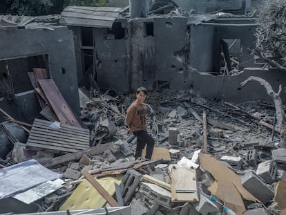 Un menor palestino, el viernes, sobre las ruinas de una casa destrozada por un bombardeo aéreo israelí en Deir Al Balah, en el sur de Gaza.