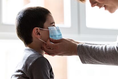 A mother puts a face mask on her son in the Basque city of Vitoria.