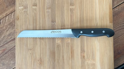 Cuchillo para cortar pan sobre una tabla de madera.