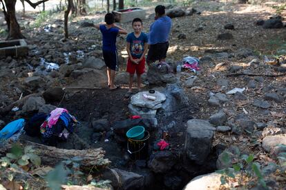 Una familia de la comunidad de Reitoca, a 45 kilómetros de Namasigüe, extrae agua de un pozo en enero de 2020. La escasez de agua afecta a cientos de familias de las comunidades de la montaña en este país.