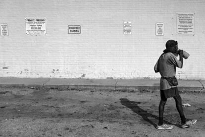 BALTIMORE, MD - NOVEMBER 02: Keith Boissiere drinks juice on the side of the Quick Mart on Belair Road on November 2, 2016 in Baltimore, Maryland. The pace of the 'Running Man' has slowed over the years and is now around the 12 minute mile mark, which typically includes one quick stop for a jug of iced tea or juice and multiple bathroom breaks during his more than 20-mile treks around Baltimore. Keith Boissiere has been running nearly every day for the past three decades - averaging more than 20 miles per day - for his health. Many residents only know the enigmatic figure by his nickname of the 'Running Man' - but Boissiere, 64, is a green-card-carrying Trinidad and Tobago native living in solitude on the border of Harlem Park and Sandtown-Winchester: two menacing neighborhoods in Baltimore City. Having never competed, nor having a desire to do so, the 'Running Man' held a daily streak of 12 and a half years which helped him earn his alias. But his health took a turn for the worse in 2008 - the streak ended - as his life almost did, too. Through all of his troubles, which includes being on a kidney donor recipient list, Boissiere copes the only way he knows how - he continues to run - as the hospital encouraged him to do in order to aid his failing health. He doesn't brag about his accomplishments or mention his celebrity-like status despite being constantly acknowledged - and these days barriers such as rain, snow and hospital appointments often dictate his running schedule. His drive and passion for his own health is often described as bringing positivity and strength to residents in the city, and the people of Baltimore still witness the 'Running Man' from West to East, and North to South, as he competes with only himself to stay upright by staying fit in a city plagued by: drugs, guns, crime, and violence.   Patrick Smith/Getty Images/AFP
== FOR NEWSPAPERS, INTERNET, TELCOS & TELEVISION USE ONLY ==