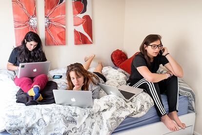 Sandy Frank, Mackenzie Hughes and Danielle Gaglioti, seen left to right, work on a start-up called Akimbo inside the apartment that Hughes and Gaglioti were subletting in San Francisco, Calif., in August 2014. The company, described as a “career development platform,” is based in New York, but Hughes and Gaglioti were in town for the summer to participate in Tumml, an urban ventures accelerator program. Frank joined them as an intern. They often worked from home depending on their meeting schedule and available transportation options. San Francisco, California. August 28, 2014. 