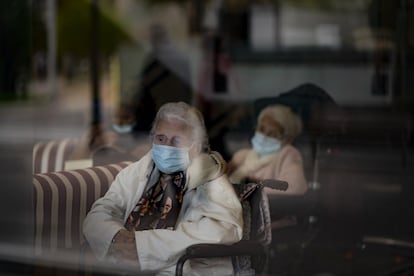 Dos ancianas observan la calle a través de una ventana en la residencia de Icaria en Barcelona, el 25 de noviembre de 2020.
