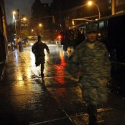 Oficiales de la Guardia nacional corren hacia el Regimiento 69 en donde permanecen durante el paso del huracán Irene en Nueva York (EE.UU.)