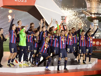 FC Barcelona's Sergio Busquets lifts the trophy as he celebrates with teammates after winning the Spanish Super Cup.