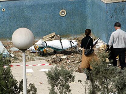 Al fondo, el cadáver de uno de los cinco suicidas, recuperado ayer de la piscina del bloque de Leganés en el que se inmolaron los terroristas.