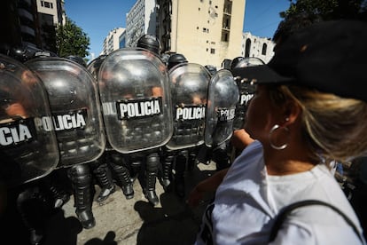Riot police officers hold their shields as they face demonstrators during a protest against Argentina's new President Javier Milei's adjustment policy