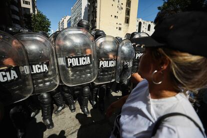 Riot police officers hold their shields as they face demonstrators during a protest against Argentina's new President Javier Milei's adjustment policy