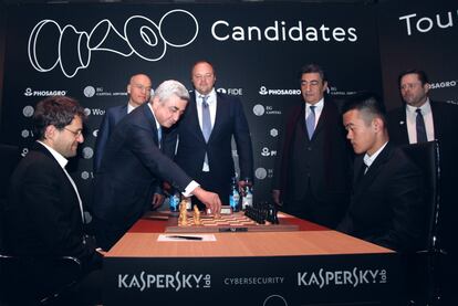 El presidente de Armenia realiza la jugada inaugural del Torneo de Candidatos en el tablero de Aronián, a la izquierda, frente a Ding