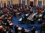 In this image from video, senators stand and applaud support staff, before the final vote on the Senate version of the COVID-19 relief bill in the Senate at the U.S. Capitol in Washington, Saturday, March 6, 2021. (Senate Television via AP)