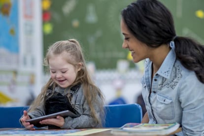 Uma menina com síndrome de Down com a professora.