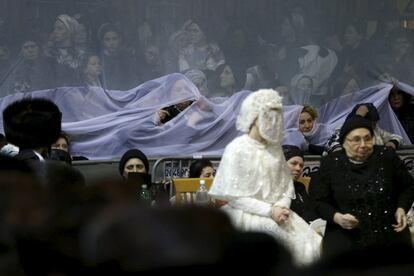 An ultra-Orthodox Jewish bride takes part in the "mitzva tantz", the custom in which relatives dance in front of the bride after her wedding ceremony, in Netanya, Israel, late March 15, 2016. Thousands took part in the wedding of the grandson of Rabbi Yosef Dov Moshe Halberstam, religious leader of the Sanz Hasidic dynasty and the granddaughter of the religious leader of Toldos Avraham Yitzchak Hasidic dynasty, in Netanya on Tuesday night. Picture taken March 15, 2016. REUTERS/Baz Ratner