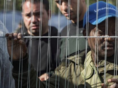 Un hombre espera para recibir ropa y calzado en un campo de refugiados construido en un parque cercano a la Oficina de Inmigraci&oacute;n de Bruselas.