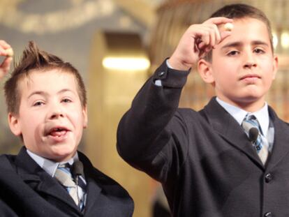 Los niños del Colegio de San Ildefonso Ivan Quintero y Andreas López muestran el número 79.250, que ha sido agraciado con el premio gordo de Navidad.