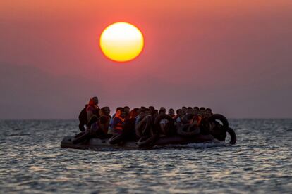 FOR USE AS DESIRED, YEAR END PHOTOS - FILE - Migrants on a dinghy arrives at the southeastern island of Kos, Greece, after crossing from Turkey, Thursday, Aug. 13, 2015. Greece has become the main gateway to Europe for tens of thousands of refugees and economic migrants, mainly Syrians fleeing war, as fighting in Libya has made the alternative route from north Africa to Italy increasingly dangerous. (AP Photo/Alexander Zemlianichenko, File)