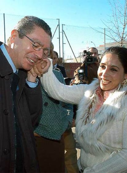 Gallardón saluda a una mujer que antes vivía en el poblado y que les ha acompañado en la visita.