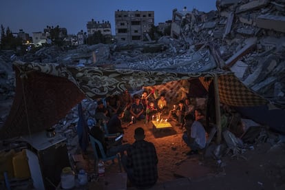 En mayo, la contienda entre israelíes y palestinos volvió a estallar. Fueron 11 días de fuego en los que fallecieron más de 250 palestinos y 13 israelíes. En la imagen, un grupo de palestinos, la mayoría niños, se alumbran con velas entre las ruinas de sus hogares destruidos por el Ejército de Israel.