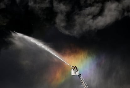 Bomberos participan en las labores de extinción de un incendio en un edificio en San Petersburgo (Rusia).