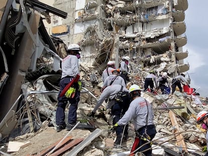 This photo provided by Miami-Dade Fire Rescue, search and rescue personnel search for survivors through the rubble at the Champlain Towers South Condo in Surfside, Fla., section of Miami,  Friday, June 25, 2021. The apartment building partially collapsed on Thursday. (Miami-Dade Fire Rescue via AP)