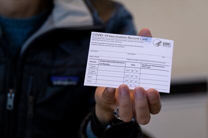 A nurse practitioner holds a COVID-19 vaccine card at a New York Health and Hospitals vaccine clinic in the Brooklyn borough of New York on Jan. 10, 2021