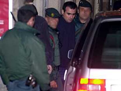 Agentes de la Guardia Civil, con uno de los detenidos (segundo por la derecha) esta madrugada en Bilbao.