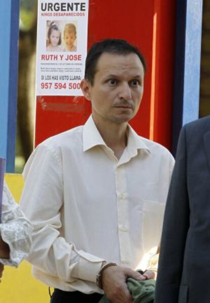 José Bretón, pictured in front of a poster seeking information about his missing children, José and Ruth.