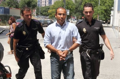 Hokman Joma is taken to court in Seville by police officers in June 2010.