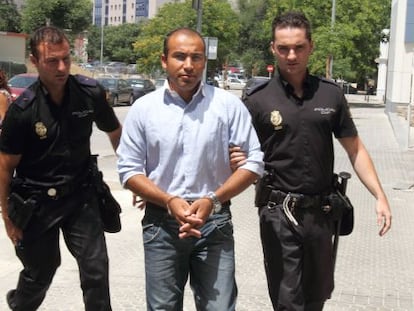 Hokman Joma is taken to court in Seville by police officers in June 2010.