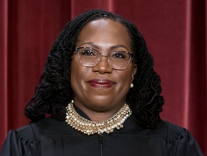 Associate Justice Ketanji Brown Jackson stands as she and members of the Supreme Court pose for a new group portrait following her addition, at the Supreme Court building in Washington, Oct. 7, 2022.