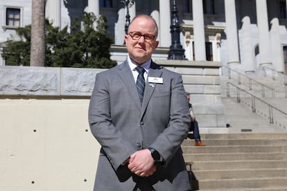 Chase Glenn, executive director of Alliance for Full Acceptance, stands outside the South Carolina Statehouse before a rally against a bill banning gender-affirming care for minors, Wednesday, Feb. 14, 2024.