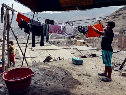 Habitantes del barrio Los Jazmines, en Lima (Perú), extienden sus ropas recién lavadas.