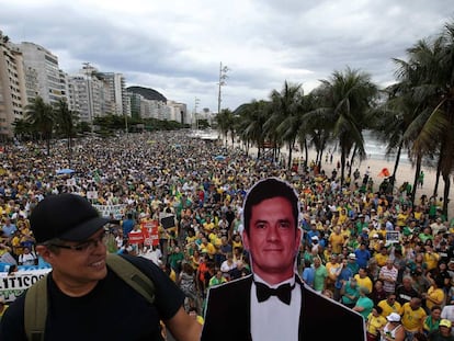 A demonstrator holds up a cardboard cutout of judge Sergio Moro.