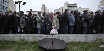Ciudadanos esperan para recibir comida gratuita, en Atenas.