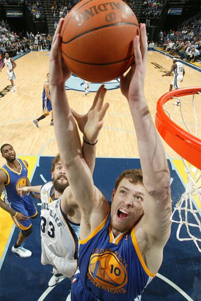 David Lee captura un rebote ante Marc Gasol.