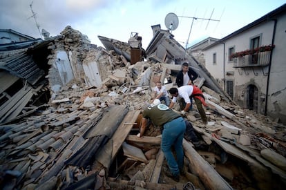 Residentes del pueblo de Amatrice buscan víctimas entre los edificios destruidos.