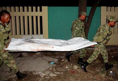 Colombian soldiers carry the body of a companion who was killed in Monday&#039;s ambush by the FARC.