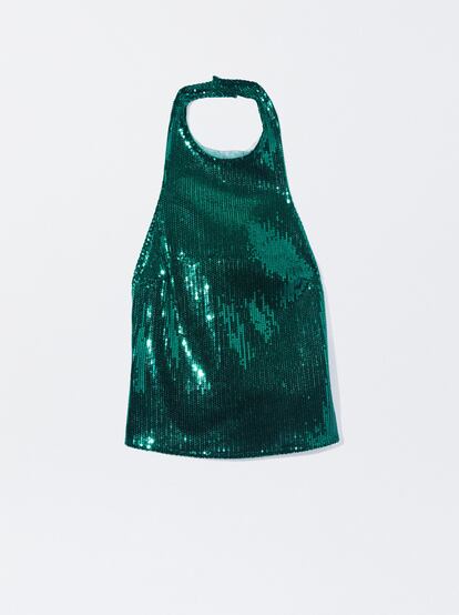 Solo necesitas unos pantalones tipo sastre para combinar con maestría este top de lentejuelas verdes de Parfois: se merece que le concedas todo el protagonismo. (29,99 €)