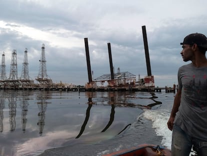 A fisherman navigates near the crumbling infrastructure of a drilling platform owned by Venezuela’s state oil company, PDVSA, on Lake Maracaibo in Cabimas, Venezuela, on May 9, 2019.