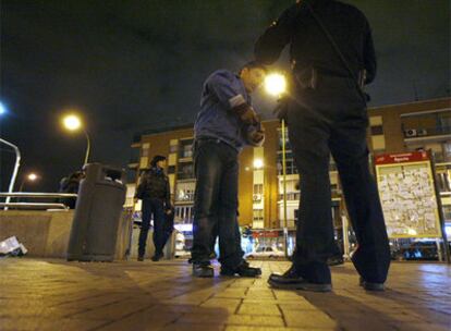 Un agente de policía pide la documentación a un inmigrante en Madrid.